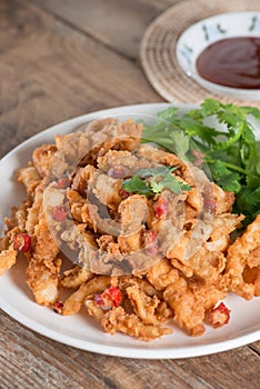 Fried squid sliced on white plate.