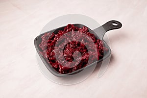 Fried or stewed beetroot in cast-iron pan, close-up, copy space