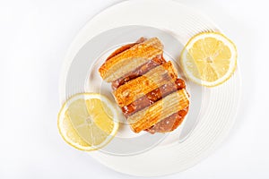 Fried Surimi Sticks With Lemons On The White Plate