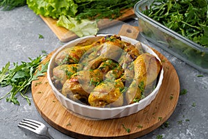 Fried tasty chicken drumstick served in white bawl with spices