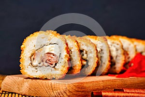 Fried tempura sushi rolls set close up selective focus. Japanese traditional fusion food style, restaurant menu