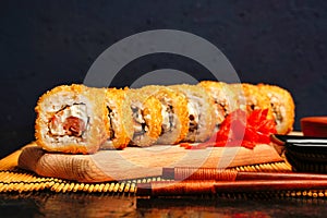 Fried tempura sushi rolls set selective focus with copy space. Japanese traditional fusion food style
