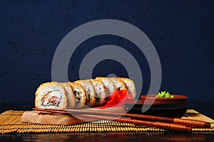Fried tempura sushi rolls set selective focus with copy space. Japanese traditional fusion food style