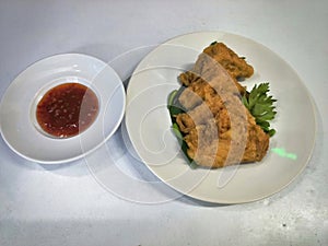fried tofu filled with vegetables and shrimp meat and sweet and sour chili sauce