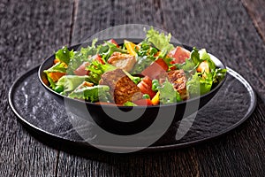 Tofu salad with greens and vegetables in bowl