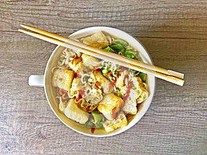 Fried Tofu spicy Asian Noodle soup with greens
