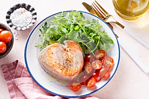 Fried tuna steak with arugula