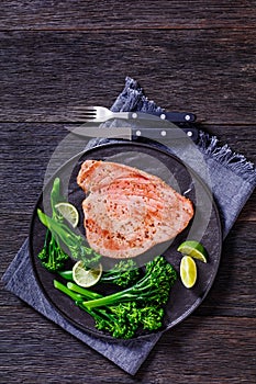 Fried tuna steak with boiled broccolini and lime