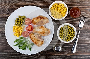 Fried turkey meat with greens and vegetables in dish, pepper