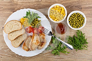 Fried turkey meat with vegetables, bread in dish, ketchup, green