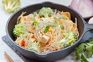 Fried vegan rice noodles with tofu and broccoli