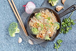 Fried vegan rice noodles with tofu and broccoli