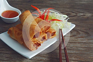 Fried vegetable spring rolls with fresh ingredients served with sweet chili sauce.