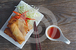 Fried vegetable spring rolls with fresh ingredients served with sweet chili sauce.
