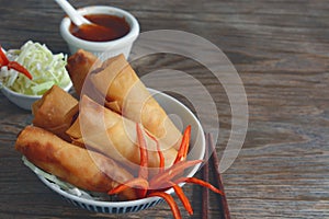 Fried vegetable spring rolls with fresh ingredients served with sweet chili sauce.