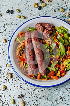 Fried veggie sausages and grilled vegetables