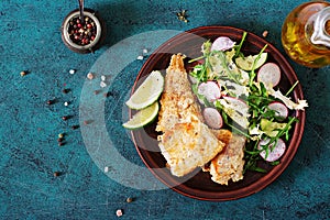 Fried white fish fillet and cucumber and radish salad.