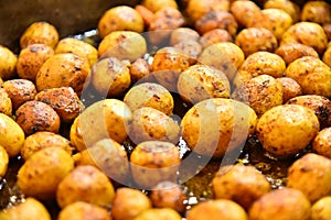 Fried whole potatoes with a golden crust, rural aromatic food