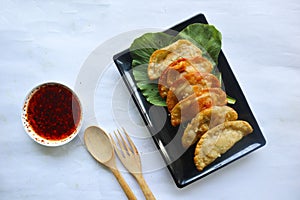 fried wonton. wonton on plate with chili oil. Shrimp or meat dumpling ,soup with mustard , green onions, on white background