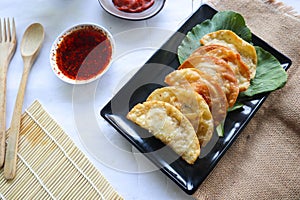 fried wonton. wonton on plate with chili oil. Shrimp or meat dumpling soup ,with mustard , green onions, on white background