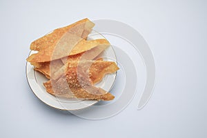 Fried wontons with minced pork meat on white background.