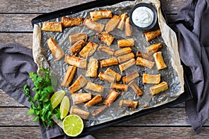 Fried yucca, yuca, cassava, manioca, mandioca with cilantro sauce