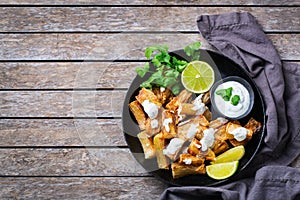 Fried yucca, yuca, cassava, manioca, mandioca with cilantro sauce