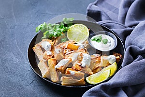 Fried yucca, yuca, cassava, manioca, mandioca with cilantro sauce