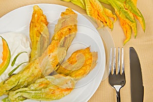 Fried zucchini flowers with cutlery