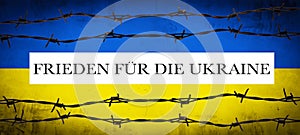 STOP WAR IN UKRAINE background - Abstract patriotic yellow blue painted colored cracked concrete wall texture with barbed wire photo