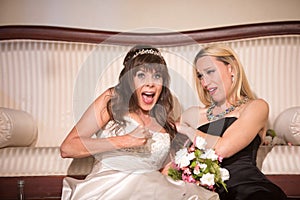 Friend Comforting Unhappy Bride while sitting on the floor