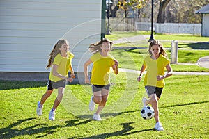 Friend girls teens playing football soccer in a park