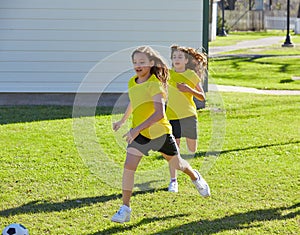 Friend girls teens playing football soccer in a park