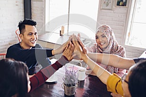 Friend giving high five at cafe