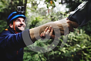 Friend holding hand to help trek