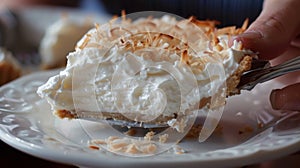 A friend trying to sneak a bite of a deliciouslooking coconut cream pie before its time for dessert photo