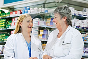 The friendliest faces youll find in pharmaceuticals. two happy women working together in a pharmacy.