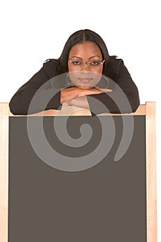 Friendly adult student leaning on chalk board