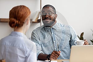 Friendly African American hr manager listening to candidate at interview