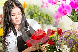 Chinese Saleswoman in a flower shop photo