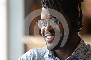 Friendly black man call center operator in headphones contact client