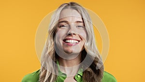 Friendly blonde woman,yes signal,approve, agree. Positive smiling lady on yellow