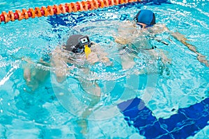 Friendly breath-holding competition. Two unrecognizable people holding breath and submerging under the surface of