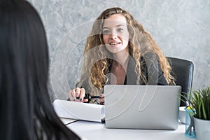 Friendly business woman interviewing new applicant candidate for marketing team staff for her team in the meeting room