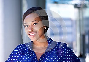 Friendly business woman smiling outside office building