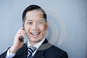 Friendly businessman with cellphone