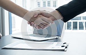 Friendly businessmen and executives shake hands after successful agreement with employment contracts, recruitment, and employment