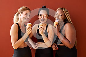 Friendly charming diverse women eating sugar tasty yummy appetiser snack photo