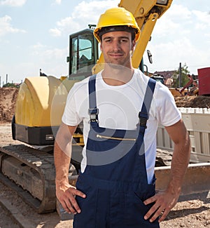 Friendly construction worker in front of his excavator