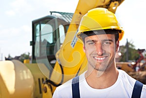 Friendly construction worker in front of his excavator